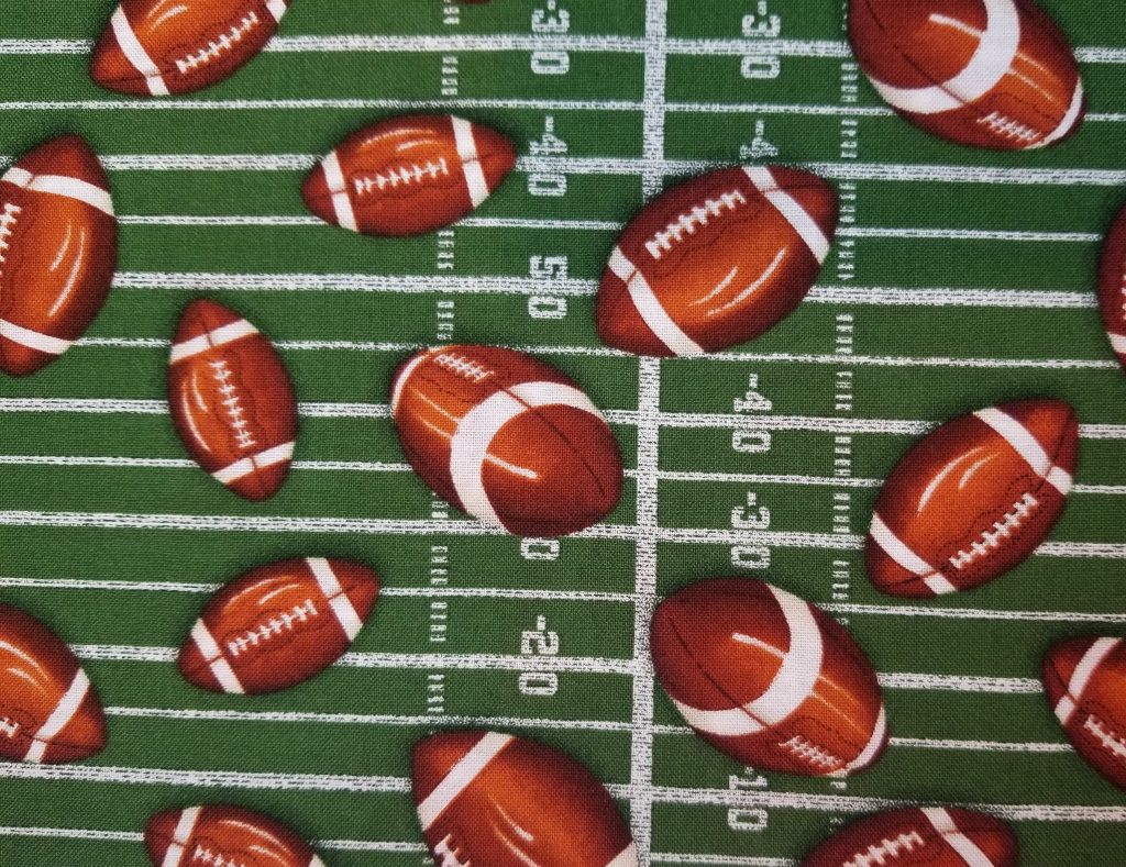 Footballs on Field Cotton Fabric By The Yard